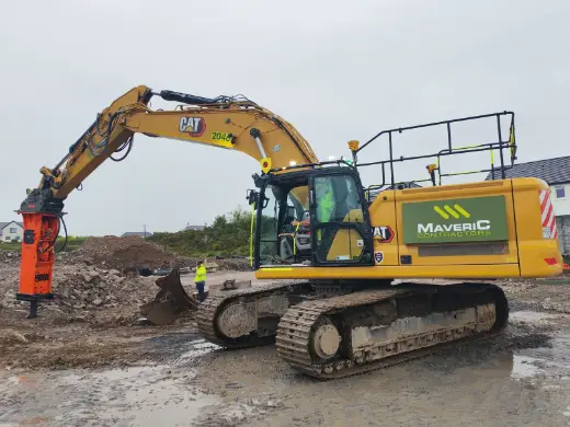 Rock breaker fitted to a Cat excavator on a groundworks site