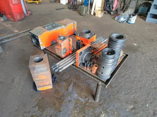 Breaker cylinder and bushes on the workshop bench