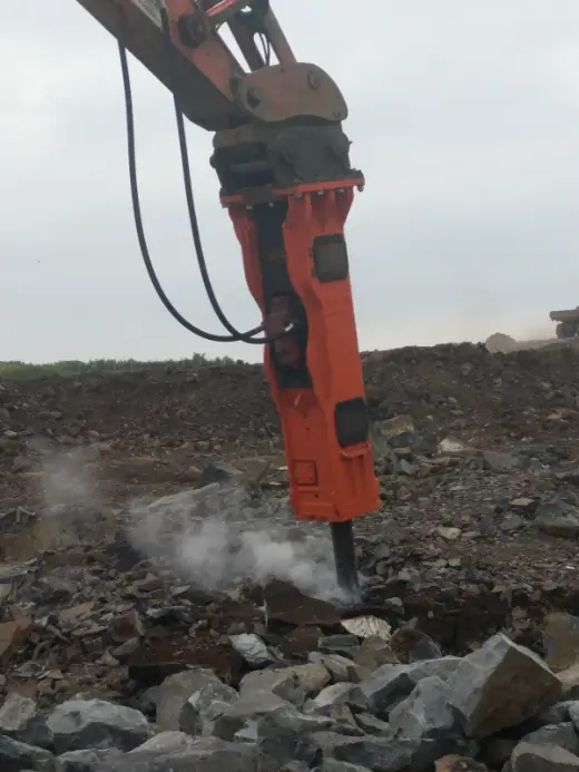 Rock breaker working a rock face