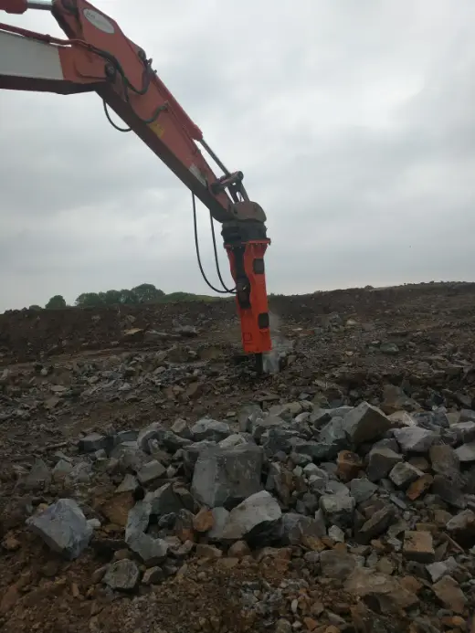 Rock breaker at work on hard ground